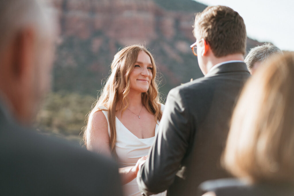 Bride and groom exchanging vows during an intimate Sedona micro wedding at sunset.